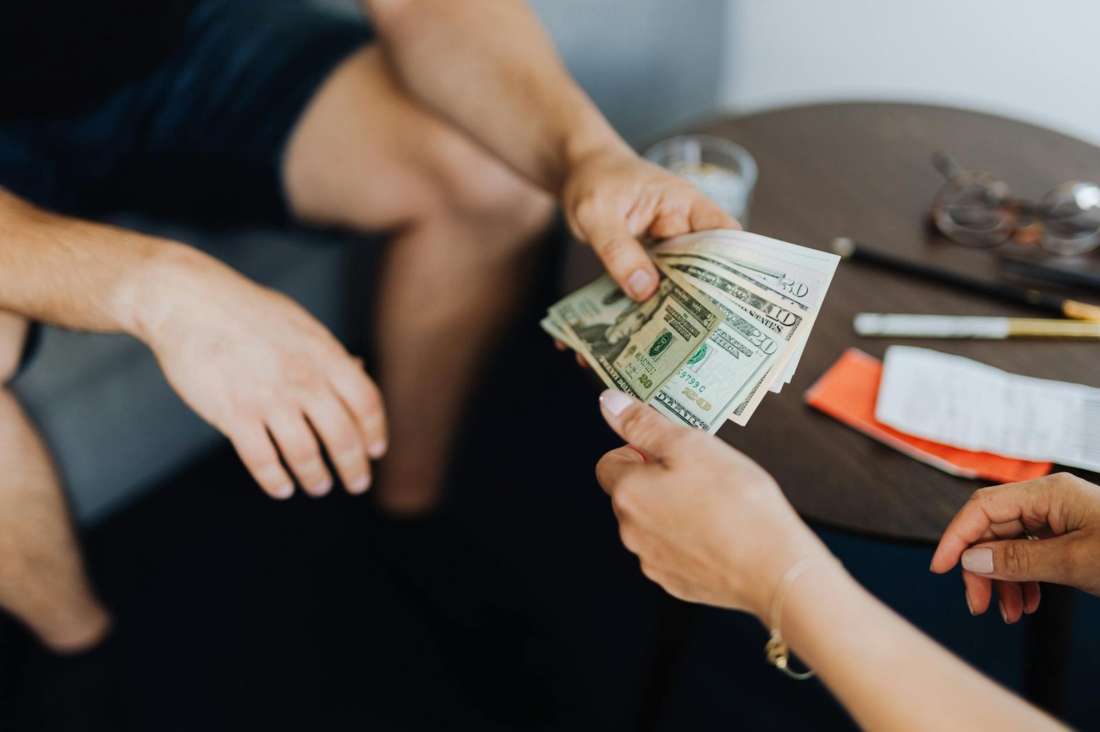 person giving money to another person